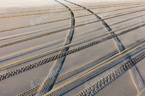 Preview: Tire tracks on the soft surface of sand on a beach.