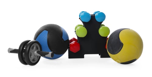 Preview: Medicine balls, dumbbells and ab wheel isolated on white
