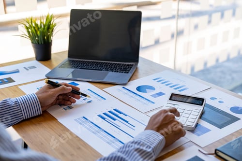 Preview: business office worker sitting at a desk using a calculator to calculate Financial data analysis and