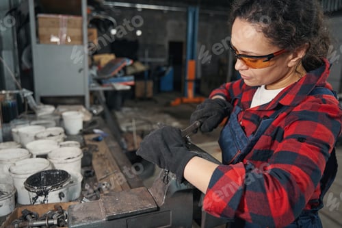 Preview: Woman auto mechanic working in car repair garage