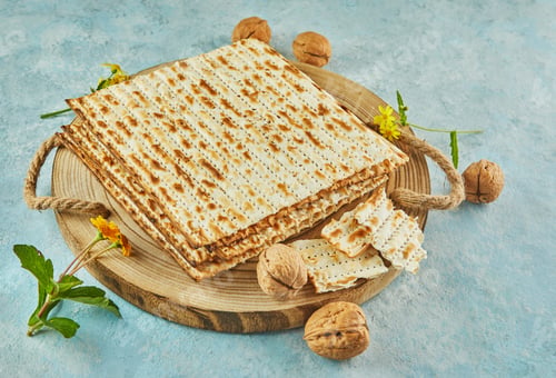 Preview: Pesach celebration concept - jewish Passover holiday. Matzah on wooden stand with nuts