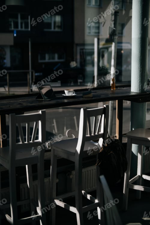Preview: Cup of coffee in an empty coffee shop