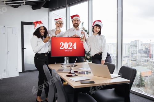 Preview: Happy successful diverse team in Santa hats of male and female workers