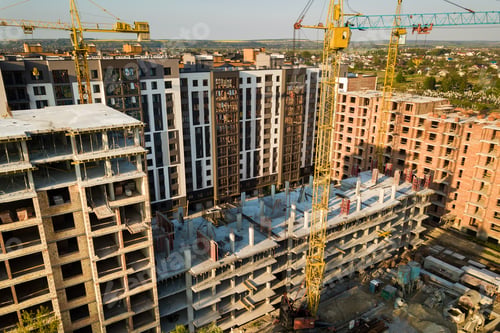 Preview: High multi storey residential apartment buildings under construction. Concrete and brick framing of