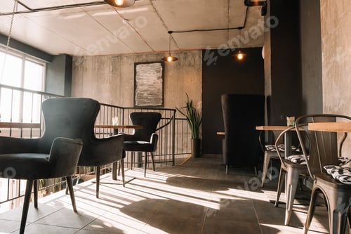Preview: balcony with tables and chairs in modern loft coffee house in sunlight