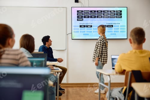 Preview: Male teacher and his students using interactive whiteboard during a class at high school.