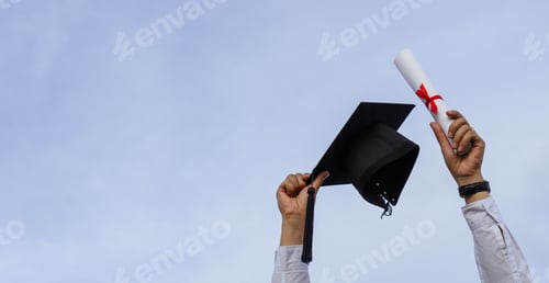 Preview: Graduation day,A certificate and a mortar board in hand with sky background,,Congratulation.
