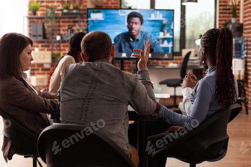 Preview: Diverse team working at company presentation discussing financial statistics