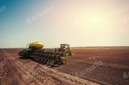 Preview: Tractor plowing farm field in preparation for spring planting