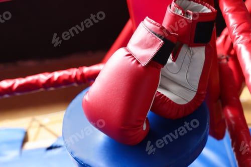 Preview: Protective gloves in corner of boxing ring. Space for text