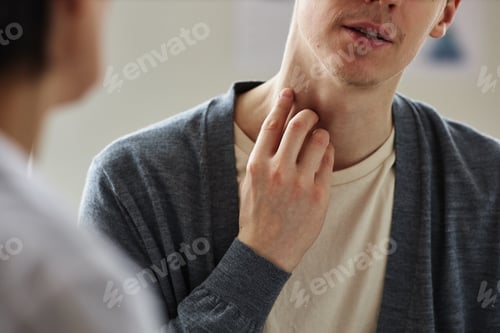 Preview: Close up of man pointing at neck skin during consultation with dermatologist