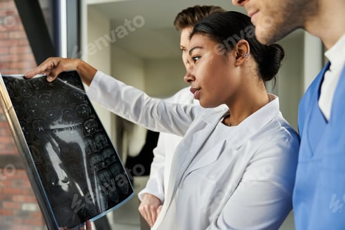 Preview: Multicultural healthcare professionals analyze medical scans in modern hospital setting