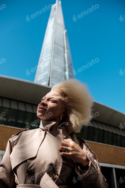 Preview: Portrait of albino female with a famous skyscraper behind in London.