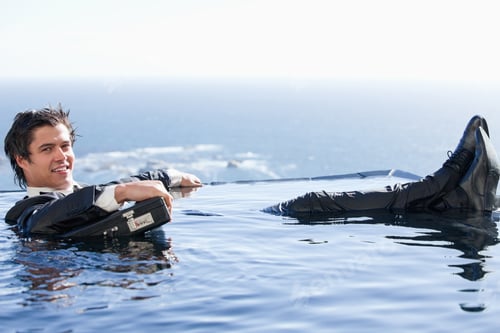 Preview: Businessman Relaxing In A Swimming Pool In A Suit