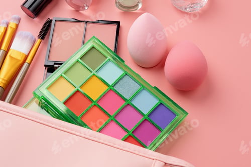 Preview: Bright summer eyeshadow palette and makeup products in pink cosmetic bag on pink background