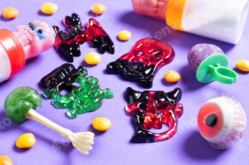 Preview: Assortmen of Halloween candies on colorful background