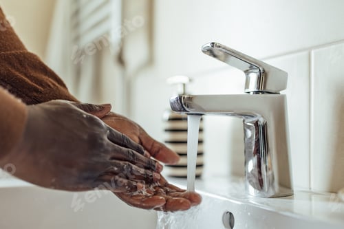 Preview: Adult man, washing his hands after using the bathroom.