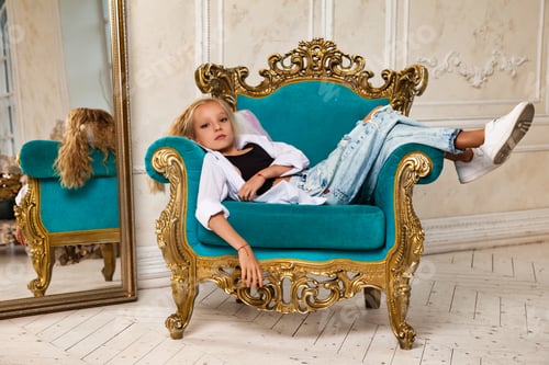 Preview: Girl Relaxing in an Ornate Teal Chair