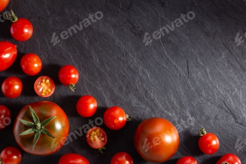 Preview: Fresh tomato on black slate background table. Tomatoes on tabletop