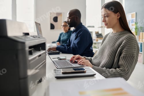 Preview: Group Of Diverse Millennials Working In Office