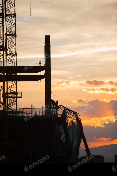 Preview: Silhouette of the construction site on sunset background