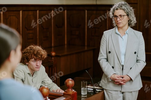 Preview: Middle Aged Caucasian Woman Listening to Young Caucasian Man Testifying in Court