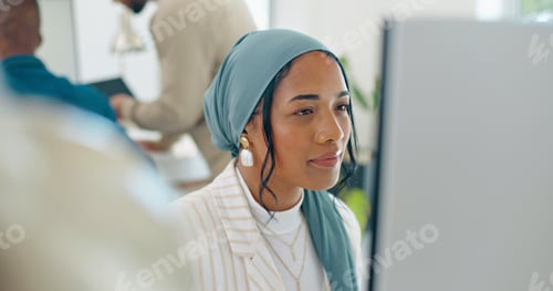 Preview: Woman, startup and desk with computer, reading and coding in modern office with islamic headscarf.