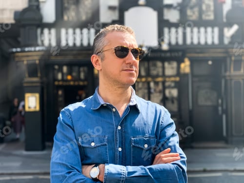 Preview: Middle aged good looking man in jeans denim blue shirt and eyeglasses. Self confident, businessman