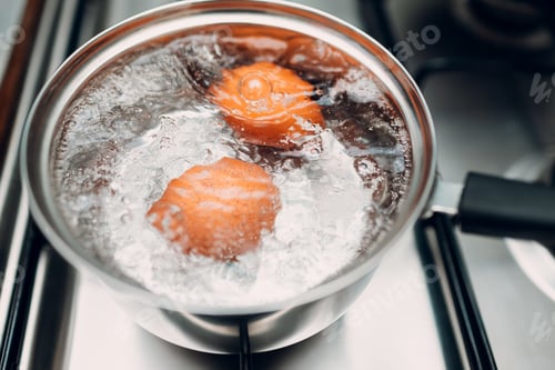 Preview: Saucepan stainless steel with boiling eggs breakfast in a water on a gas stove
