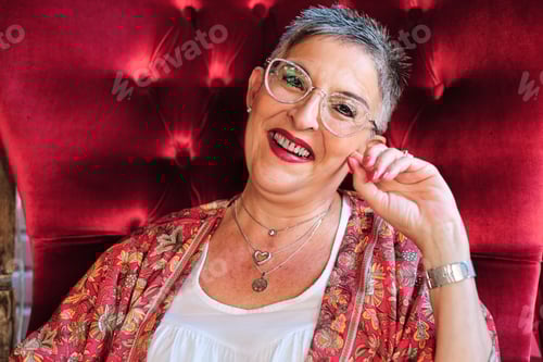 Preview: Smiling Woman Poses in a Red Chair