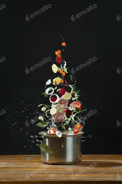 Preview: Fresh vegetables falling into a stainless steel casserole