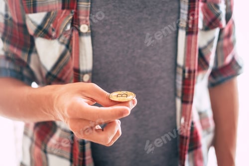 Preview: teenager standing and playing with bitcoin