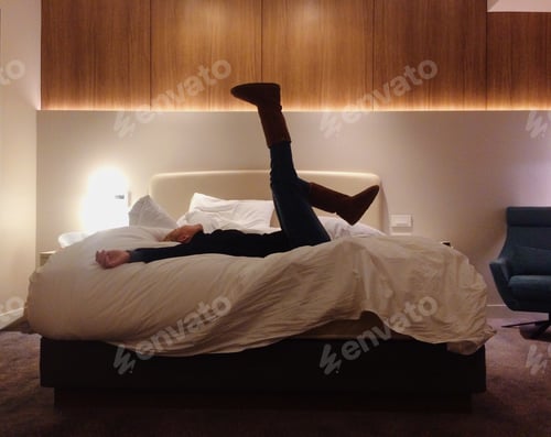 Preview: Tied woman laying down in the bed wearing clothes