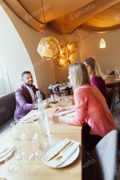 Preview: Friends talking while sitting at Lebanese restaurant