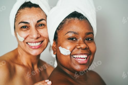 Preview: Multiracial senior and young women doing beauty treatment using skin masks