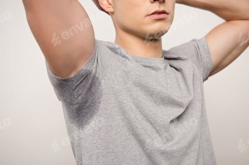 Preview: cropped view of young man in grey t-shirt with sweaty underarm isolated on grey