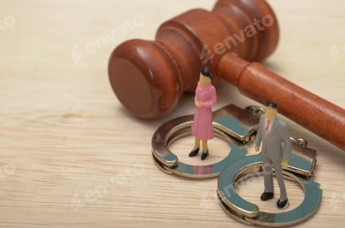 Preview: Couple Facing Legal Troubles: Miniature Figures and Gavel Symbolizing Courtroom Drama