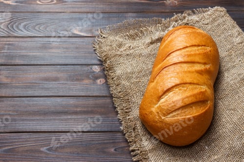 Preview: loaf of bread on wooden background, food closeup