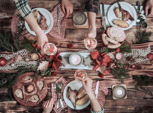 Preview: Flat-lay of friends hands eating and drinking together.