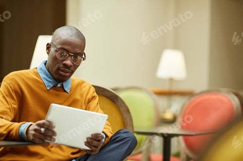 Preview: Modern African Man Relaxing in Cafe