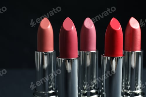 Preview: Different lipsticks on dark background. Cosmetic product