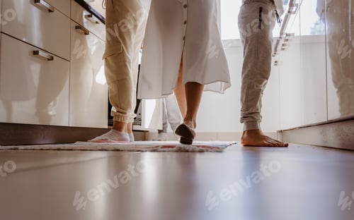 Preview: Family cooking together at home - unusual angle of shooting, focus on the legs