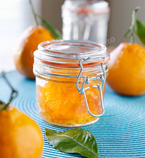 Preview: jar of homemade orange jam with closed lid