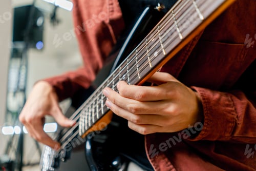 Preview: musician with electric guitar in recording studio plays musical instrument presses fingers strings