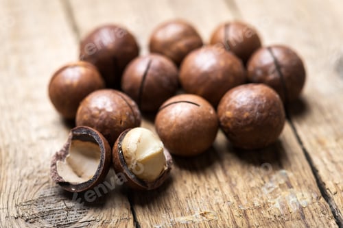 Preview: Dried organic Macadamia nuts in orange ceramic bowl