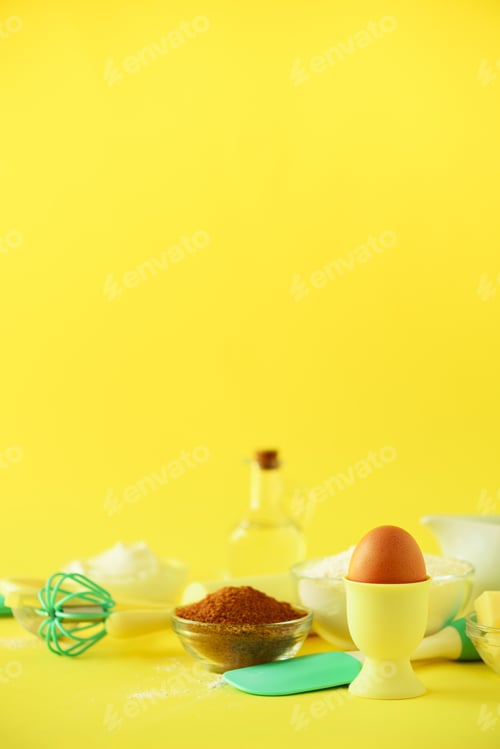 Preview: Turquoise and yellow cooking utensils on bright background. Food ingredients. Macro of eggs. Cooking