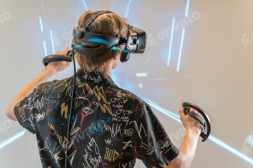 Preview: Young man in 3D virtual reality glasses. VR glasses and helmet. Futuristic and modern
