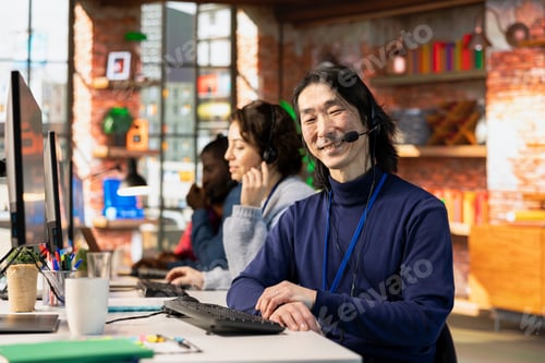 Preview: Portrait of happy call center worker doing customer service job