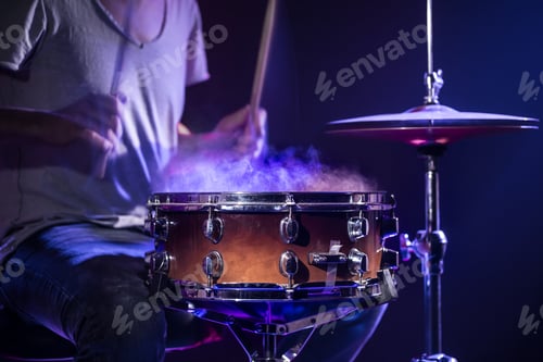 Preview: A drummer plays drums on a blue background. Beautiful special effects of light and smoke.