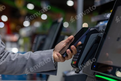 Preview: A person is making a payment using NFC technology on a mobile device at a pointofsale terminal in a